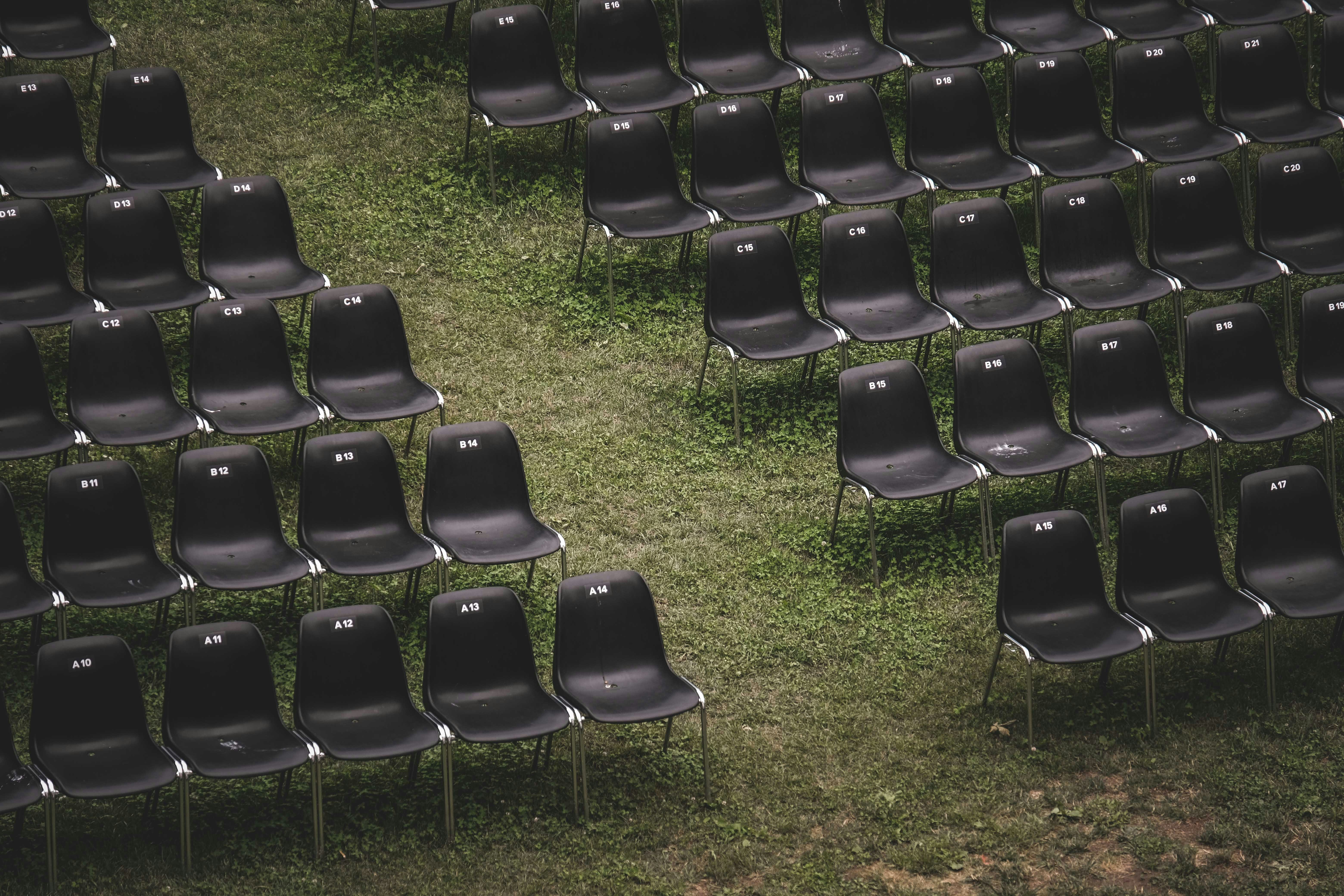 black metal chairs on green grass field during daytime